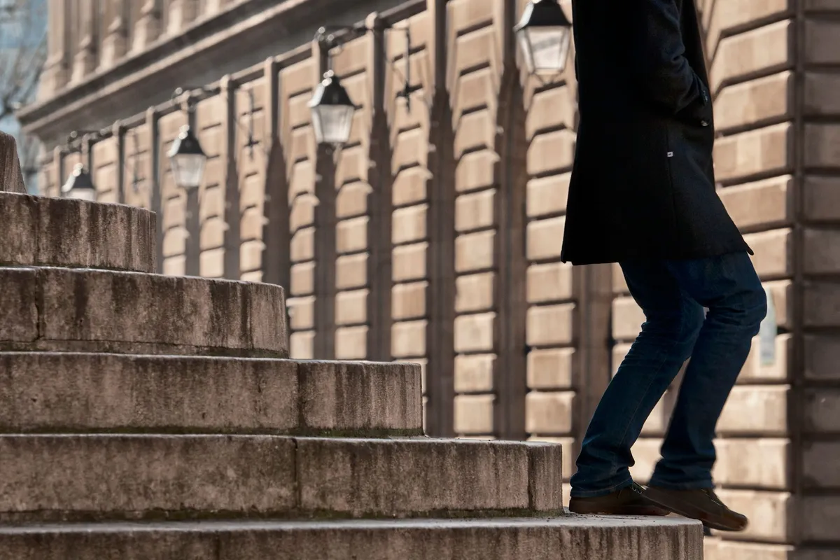 A person climbing stone steps outdoors