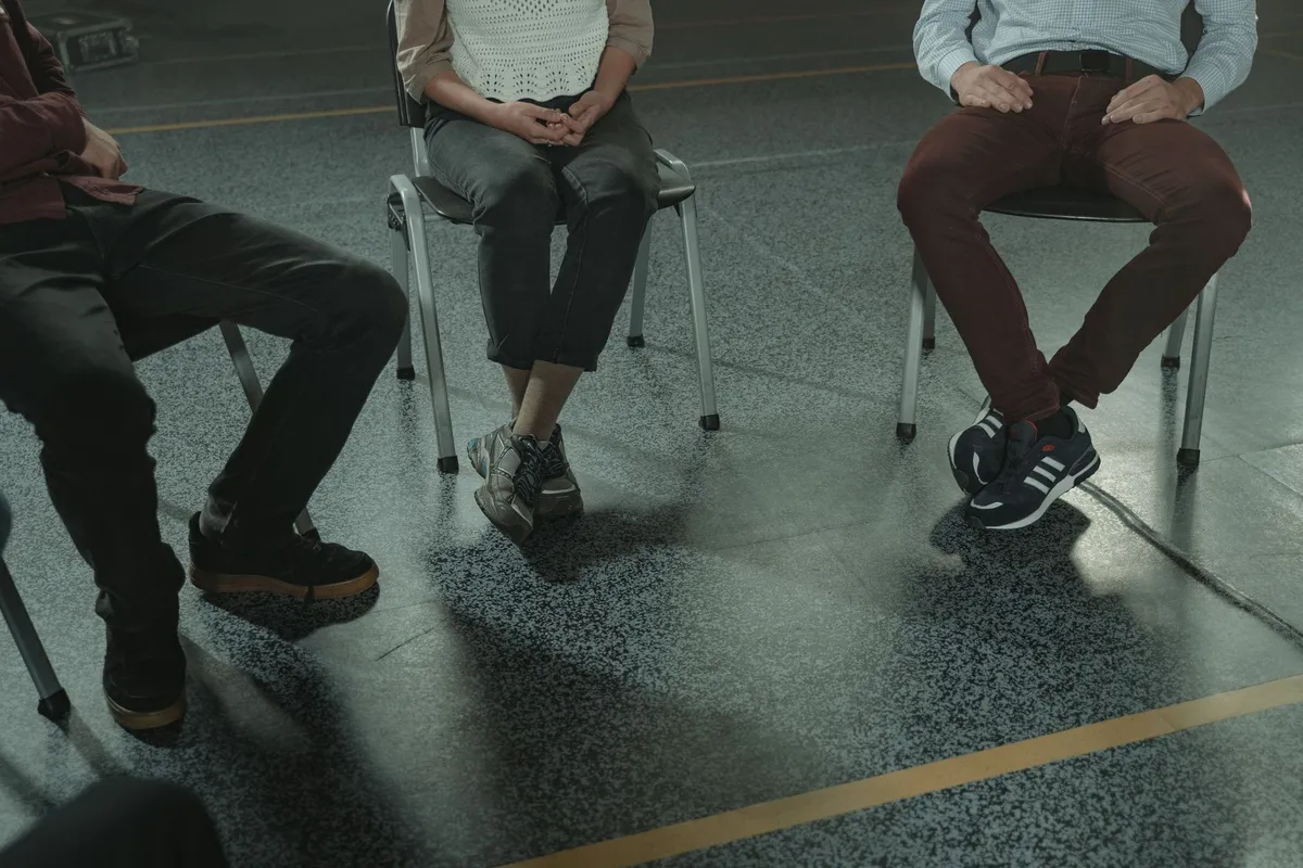 People sitting in a circle in a betrayal trauma group counseling session