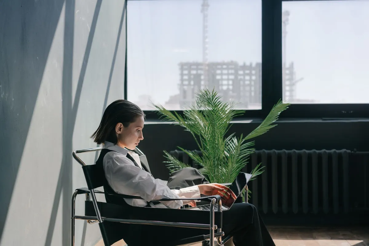 A quiet therapy room with an armchair beside a window in daylight
