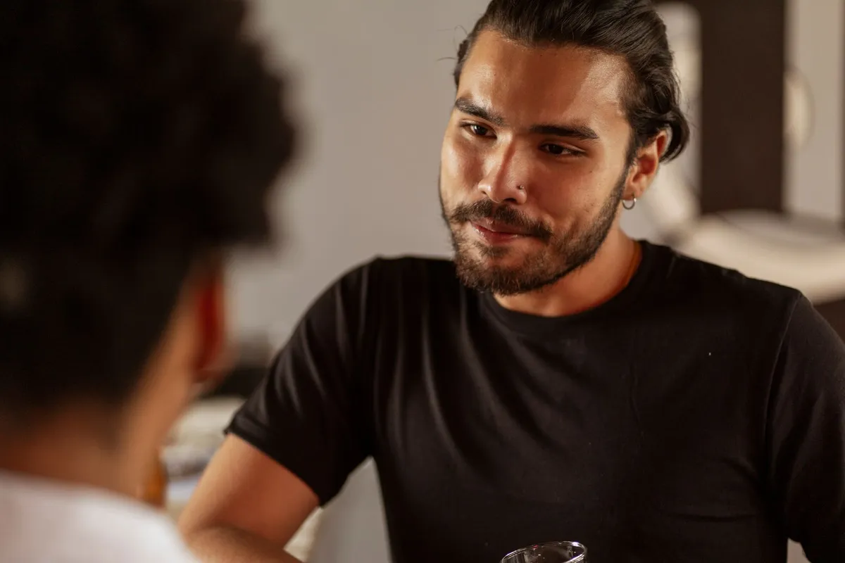 A man listening intently during a serious conversation indoors