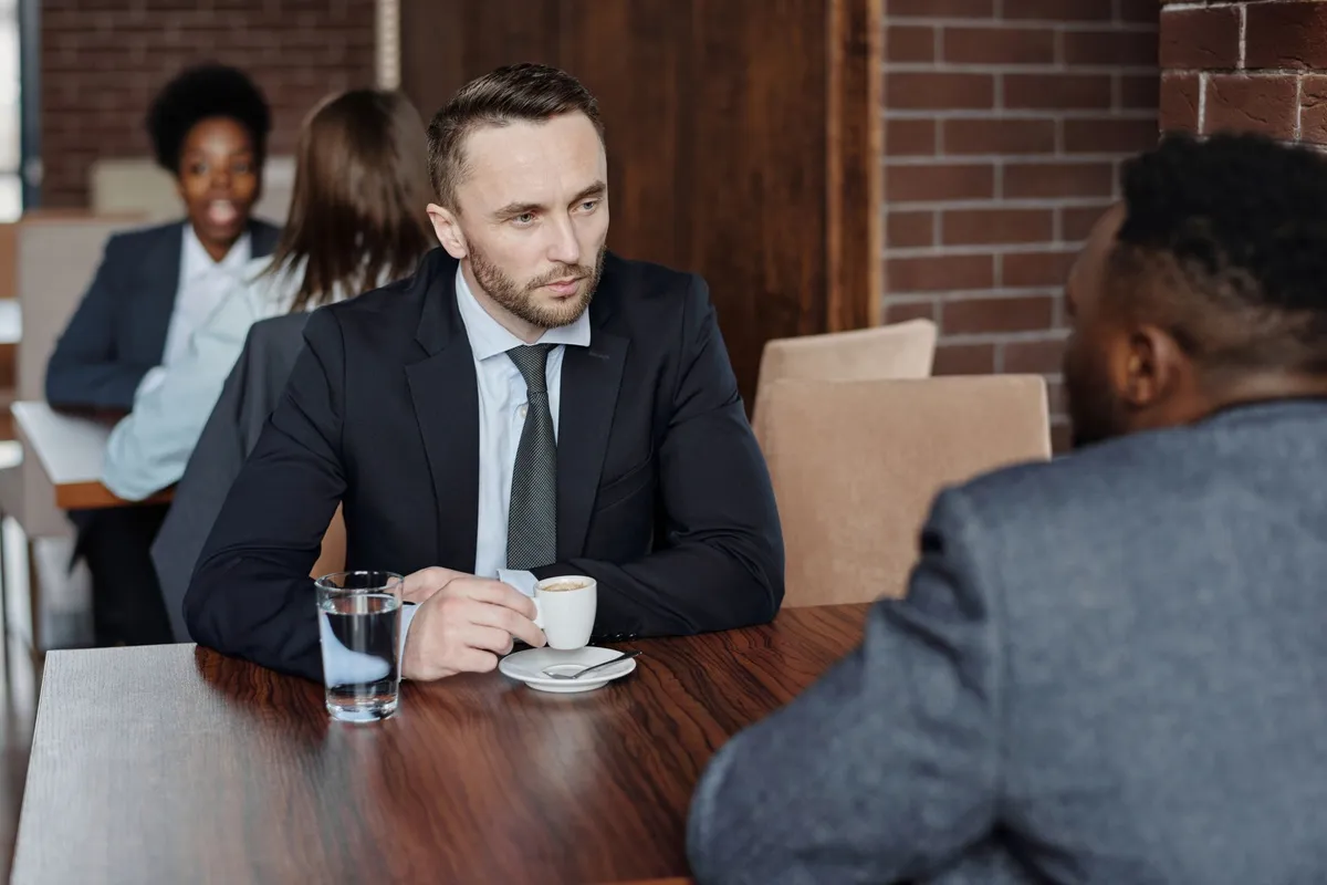 Two people in a serious conversation across a table