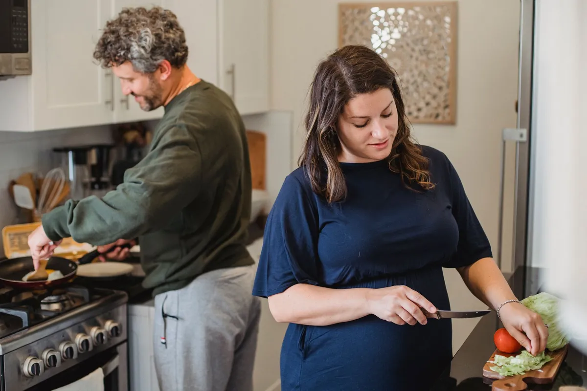 A couple cooking together in a kitchen