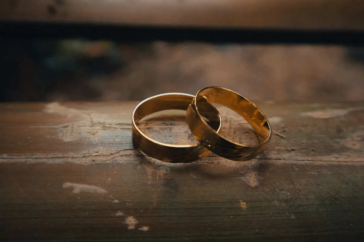 Two wedding rings set down on a table, the question of how to know if your marriage is over