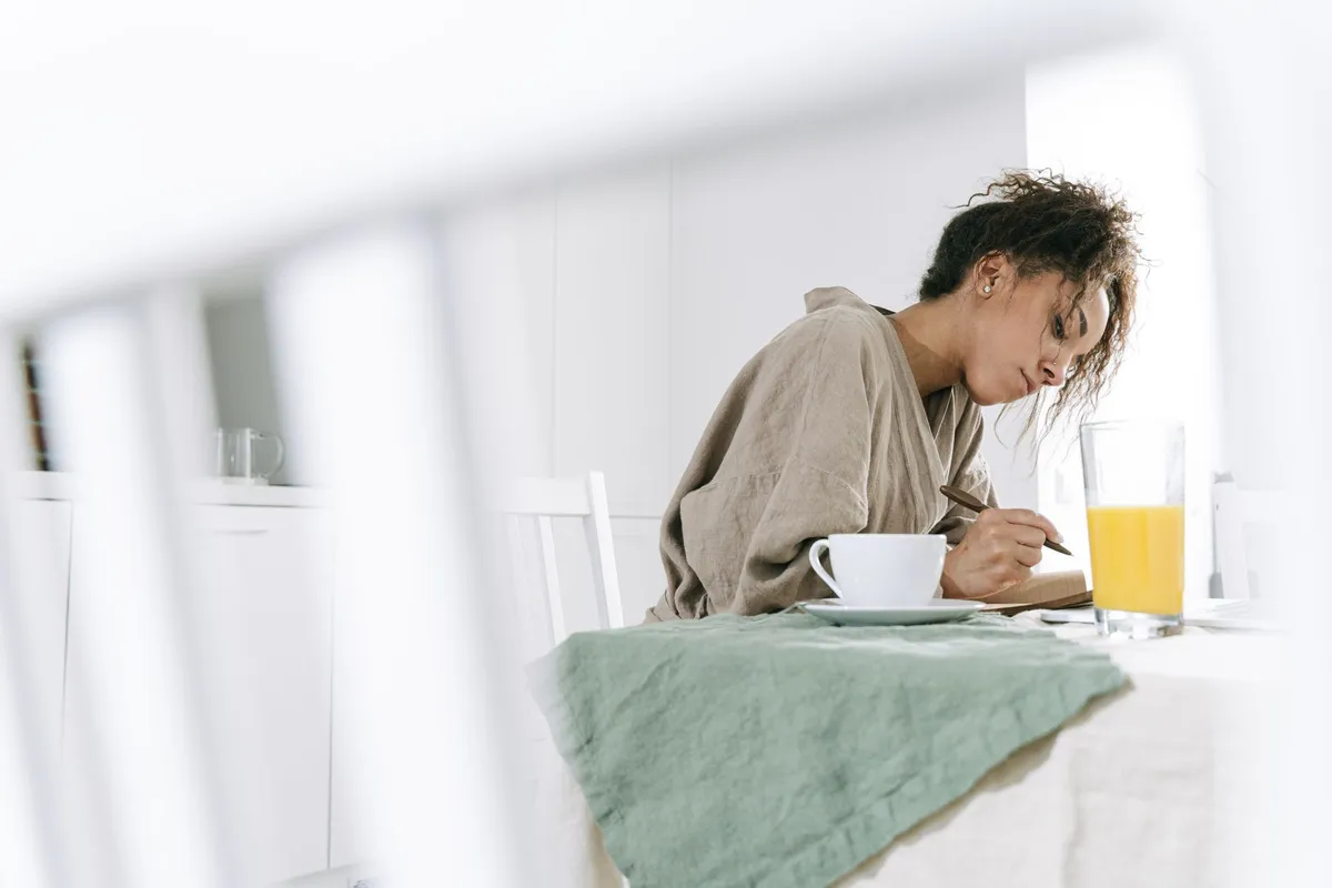 A notebook and pen on a kitchen table, ready for the two-list test on whether a marriage is over