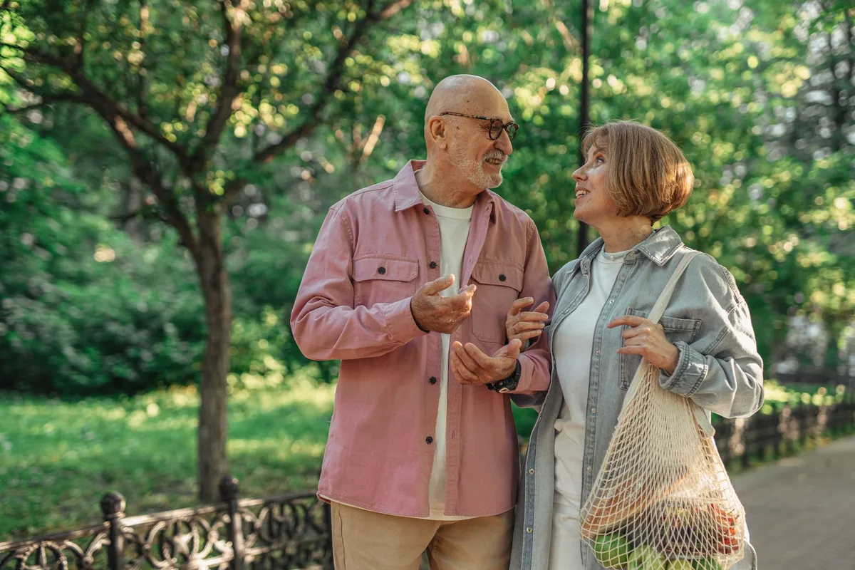 A couple walking outdoors together, talking