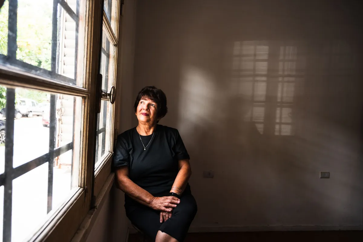 A woman sitting alone in morning light, thinking through what to do after cheating on her husband