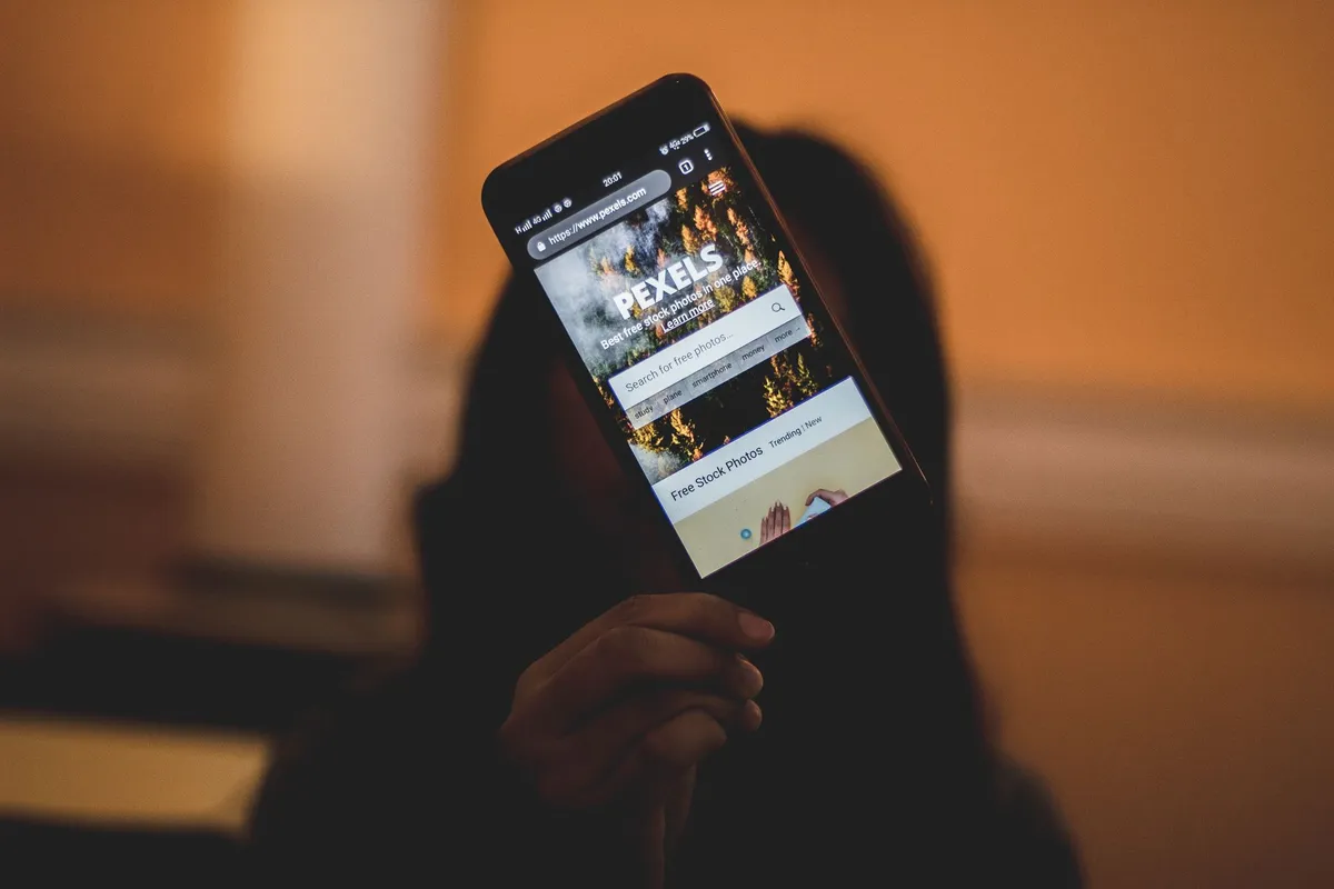A man searching his phone at night for porn addiction counseling near me