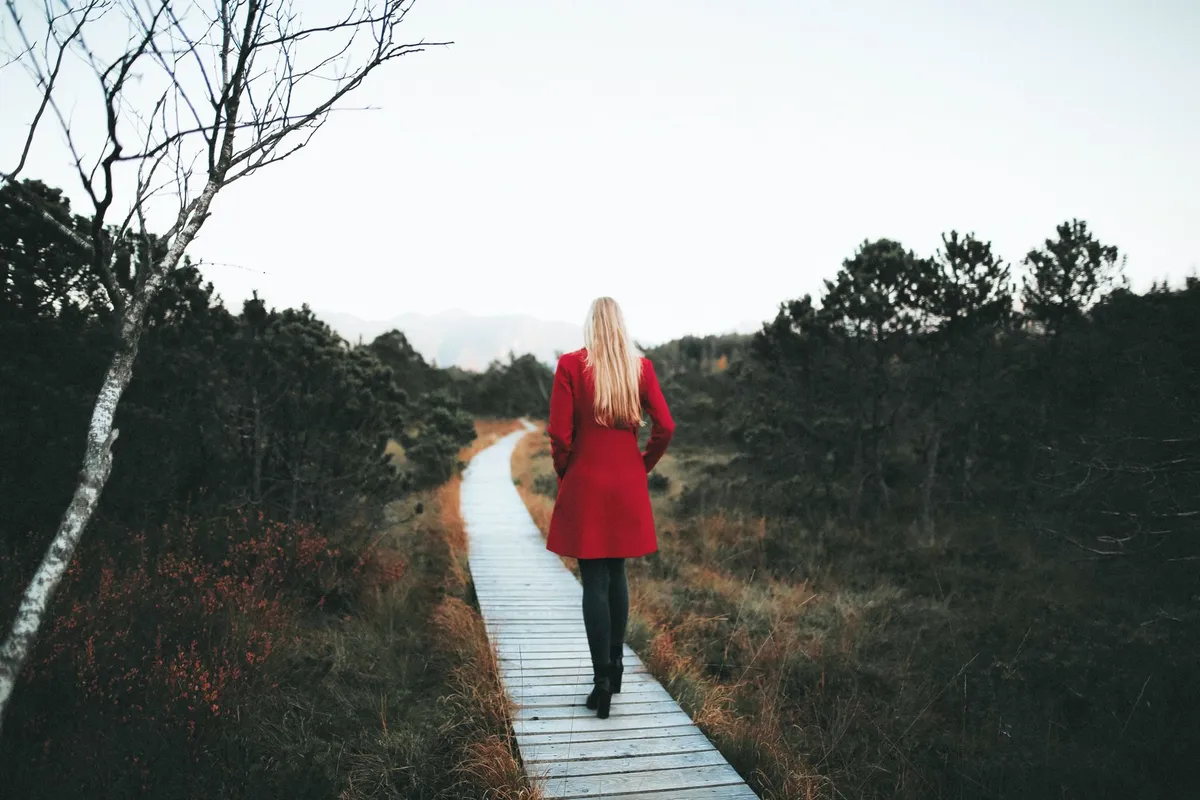 A woman walking alone on a path, thinking things through