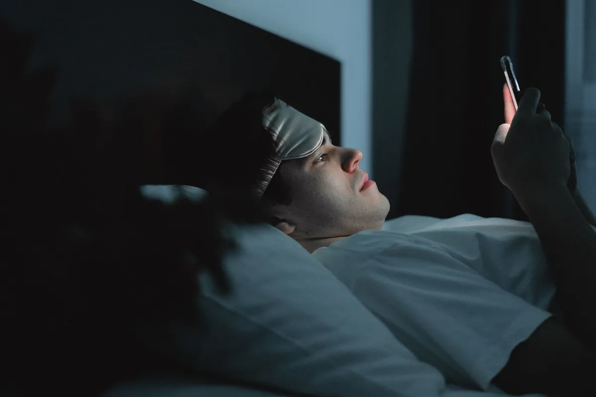 A man texting late in the evening, the private communication that marks an emotional affair